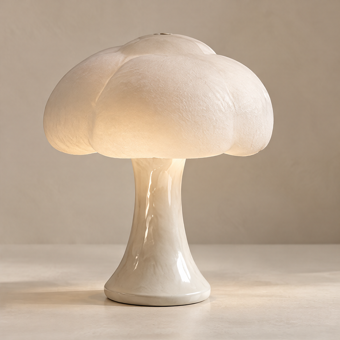 Clean product shot – Cloud-Form Mushroom Table Lamp on neutral background, glowing warm light through textured cloud shade on glossy ceramic base