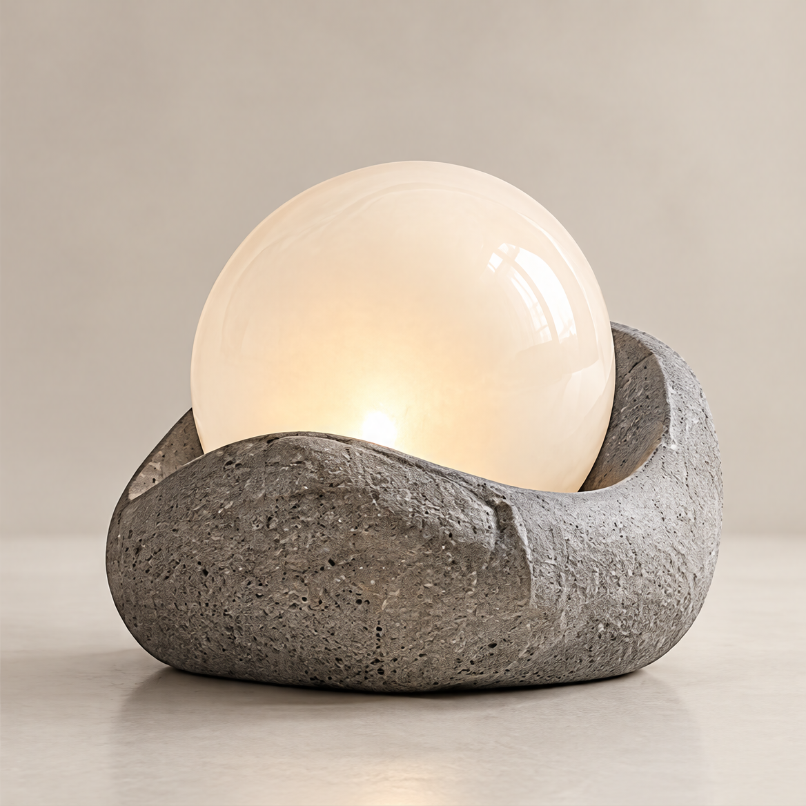Clean product shot – Stone-Form Globe Table Lamp on neutral background, porous stone base with warm glowing white globe