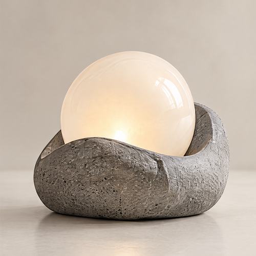 Clean product shot – Stone-Form Globe Table Lamp on neutral background, porous stone base with warm glowing white globe